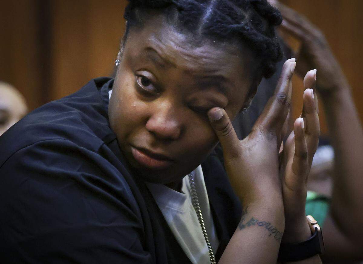 Older sister to Yahkeim “Keimo” Lollar, a student athlete from Northwestern High School who was stabbed by his girlfriend Jahara Malik, wipes away tears during Malik’s pre-trial hearing on Thursday, Feb. 6, 2025, at the Richard E. Gerstein Justice Building in downtown Miami.  His older sister helps their mother with care of other siblings. 